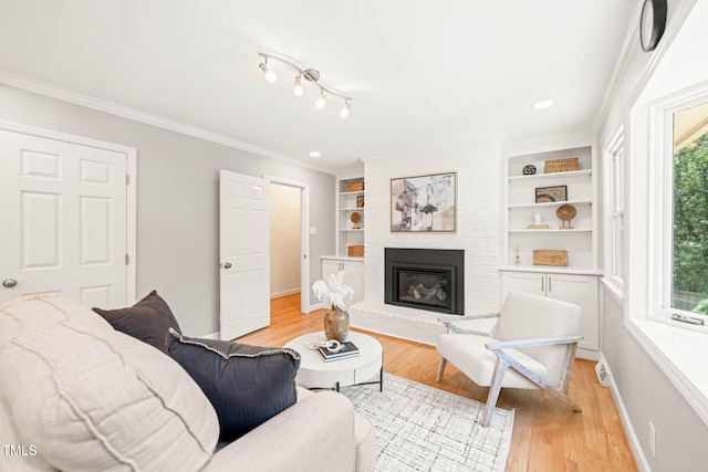 3420 Sheridan Dr, Durham, NC 27707 - living room featuring plenty of natural light, light wood-style floors, a fireplace, baseboards, and ornamental molding