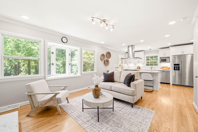 3420 Sheridan Dr, Durham, NC 27707 - living area with crown molding, light wood-style floors, baseboards, and recessed lighting