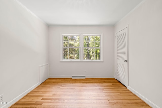 3420 Sheridan Dr, Durham, NC 27707 - unfurnished bedroom with crown molding, light wood-style floors, baseboards, and a closet