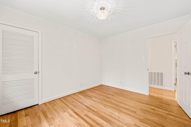 3420 Sheridan Dr, Durham, NC 27707 - spare room with light wood-type flooring, crown molding, a chandelier, and baseboards