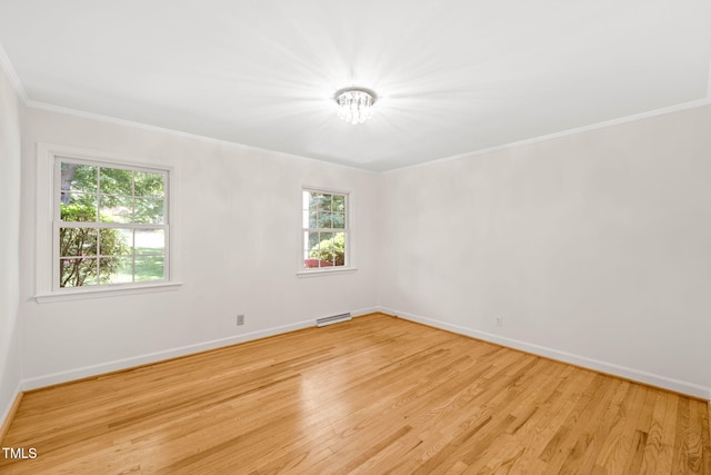 3420 Sheridan Dr, Durham, NC 27707 - empty room featuring baseboards, light wood-style flooring, and crown molding