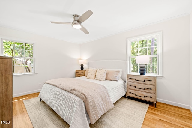 3420 Sheridan Dr, Durham, NC 27707 - bedroom featuring multiple windows, baseboards, light wood-type flooring, and ornamental molding