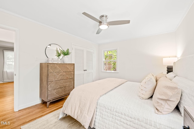 3420 Sheridan Dr, Durham, NC 27707 - bedroom with light wood finished floors, ornamental molding, baseboards, a closet, and a ceiling fan