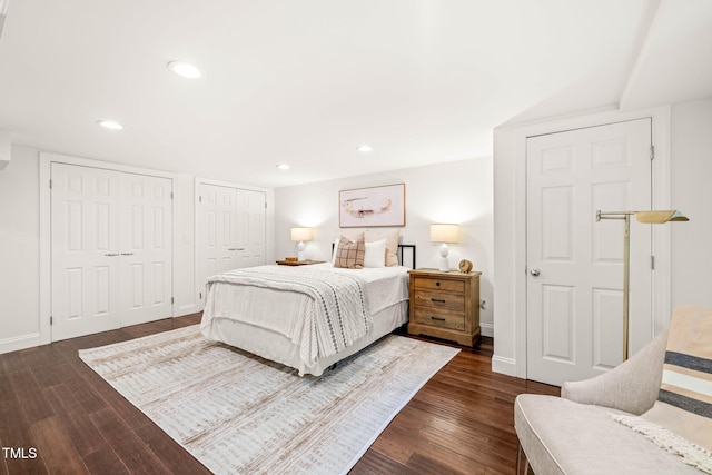 3420 Sheridan Dr, Durham, NC 27707 - bedroom featuring dark wood-style flooring, two closets, baseboards, and recessed lighting