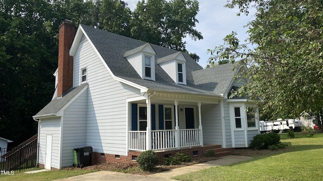 3832 Doeskin Dr, Apex, NC 27539 - cape cod house featuring covered porch, a chimney, a front yard, crawl space, and roof with shingles
