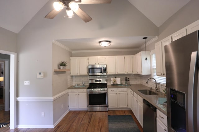 3832 Doeskin Dr, Apex, NC 27539 - kitchen featuring appliances with stainless steel finishes, a sink, vaulted ceiling, dark wood-style flooring, and backsplash