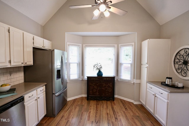 3832 Doeskin Dr, Apex, NC 27539 - kitchen with stainless steel appliances, white cabinets, wood finished floors, backsplash, and healthy amount of natural light