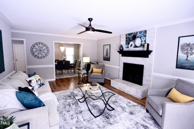 3832 Doeskin Dr, Apex, NC 27539 - living area with wood finished floors, crown molding, ceiling fan, a brick fireplace, and baseboards