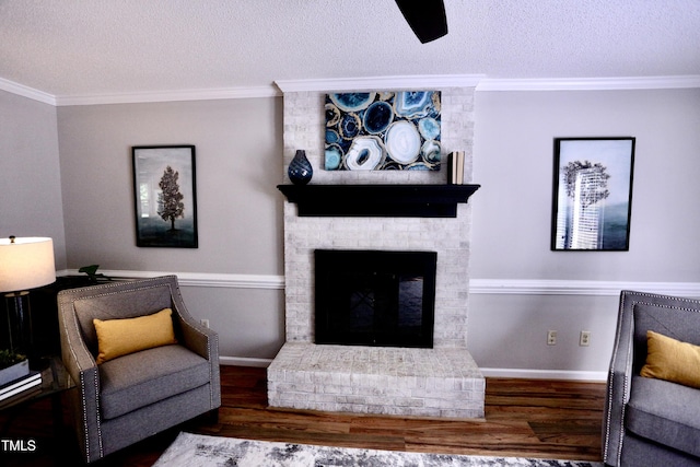 3832 Doeskin Dr, Apex, NC 27539 - living room with wood finished floors, a textured ceiling, baseboards, a fireplace, and crown molding