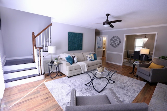 3832 Doeskin Dr, Apex, NC 27539 - living area featuring stairs, wood finished floors, crown molding, baseboards, and a ceiling fan
