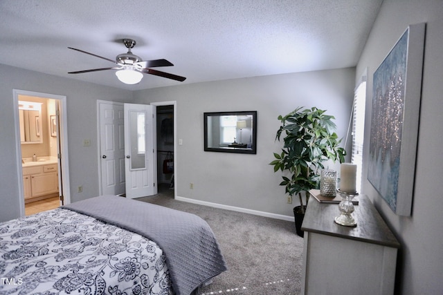 3832 Doeskin Dr, Apex, NC 27539 - carpeted bedroom featuring a textured ceiling, ensuite bathroom, baseboards, a ceiling fan, and a sink