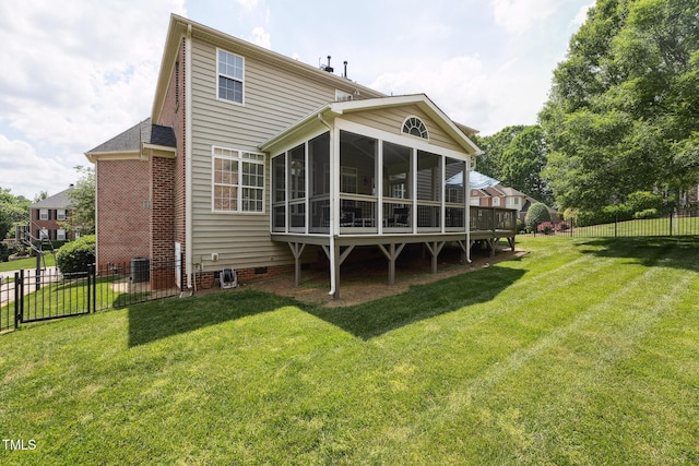 rear view of house with a lawn, crawl space, a fenced backyard, and a sunroom