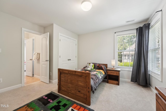 carpeted bedroom with baseboards and visible vents
