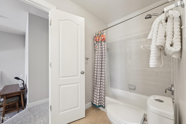 bathroom with toilet, tile patterned floors, baseboards, and shower / tub combo