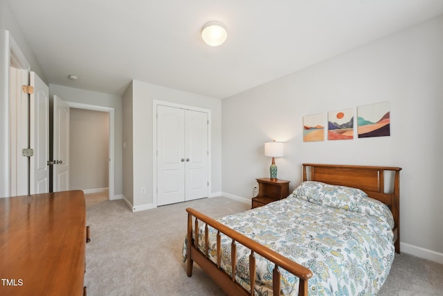 bedroom with a closet, carpet flooring, and baseboards