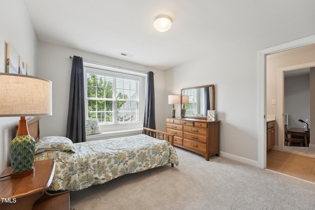 bedroom featuring baseboards, visible vents, and carpet