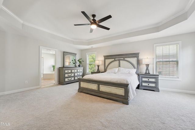 bedroom with crown molding, a raised ceiling, carpet floors, and baseboards