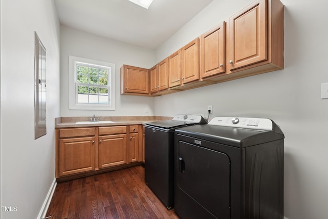 laundry room with cabinet space, a sink, separate washer and dryer, baseboards, and dark wood-style floors