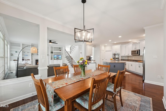 dining area with ceiling fan with notable chandelier, stairs, baseboards, dark wood-type flooring, and ornamental molding