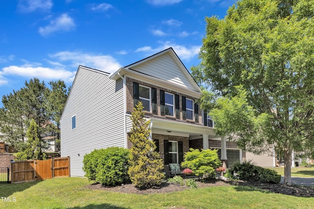 3801 Althorp Dr, Raleigh, NC 27616 - view of front facade with a front lawn, fence, brick siding, a gate, and a porch