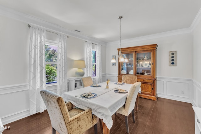 3801 Althorp Dr, Raleigh, NC 27616 - dining space with visible vents, crown molding, wainscoting, a decorative wall, and dark wood-type flooring