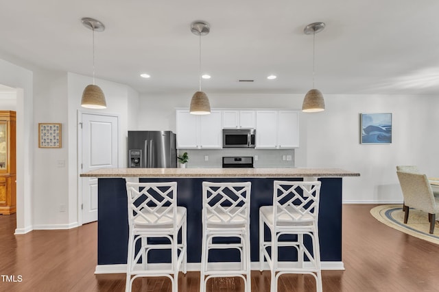 3801 Althorp Dr, Raleigh, NC 27616 - kitchen with baseboards, light countertops, dark wood-style flooring, and appliances with stainless steel finishes