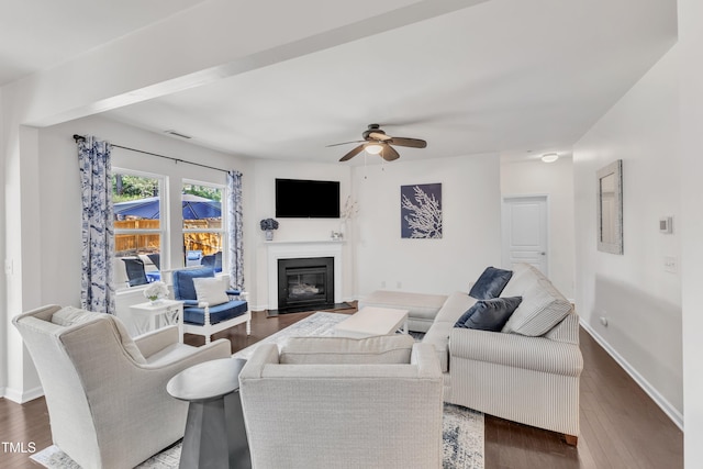 3801 Althorp Dr, Raleigh, NC 27616 - living area with a ceiling fan, dark wood-style flooring, visible vents, a fireplace with flush hearth, and baseboards