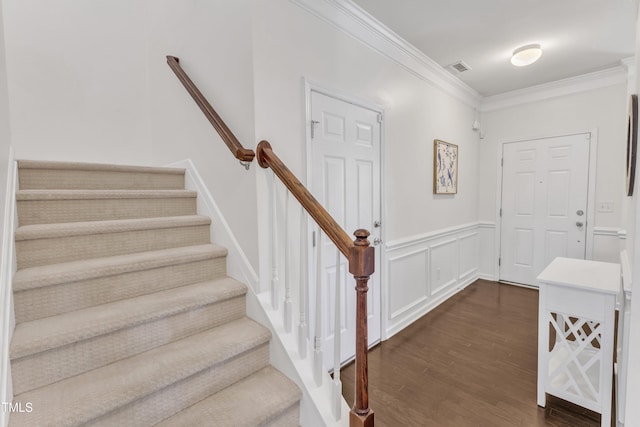 3801 Althorp Dr, Raleigh, NC 27616 - staircase with visible vents, ornamental molding, wainscoting, and wood finished floors