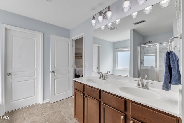 3801 Althorp Dr, Raleigh, NC 27616 - ensuite bathroom featuring visible vents, tile patterned flooring, double vanity, a shower stall, and a sink