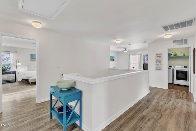 3801 Althorp Dr, Raleigh, NC 27616 - hall featuring visible vents, light wood finished floors, baseboards, and washer and dryer