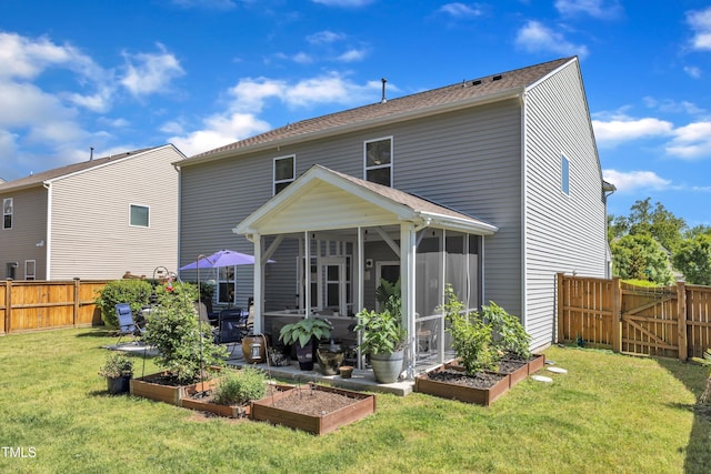 3801 Althorp Dr, Raleigh, NC 27616 - rear view of house with a lawn, a garden, a fenced backyard, and a sunroom