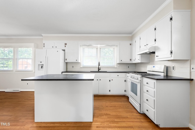 2917 Trail Six, Burlington, NC 27215 - kitchen featuring white appliances, a sink, under cabinet range hood, dark countertops, and ornamental molding