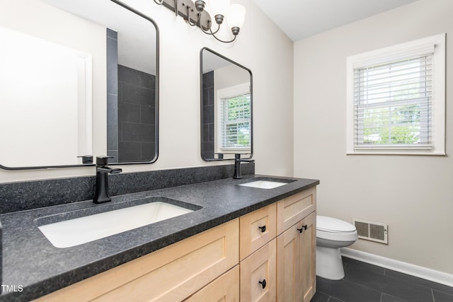 2917 Trail Six, Burlington, NC 27215 - full bathroom featuring double vanity, toilet, tile patterned floors, and baseboards
