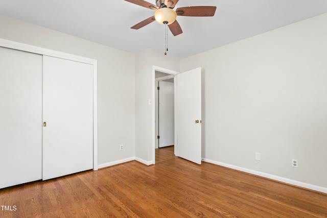 2917 Trail Six, Burlington, NC 27215 - unfurnished bedroom featuring baseboards, wood finished floors, a ceiling fan, and a closet