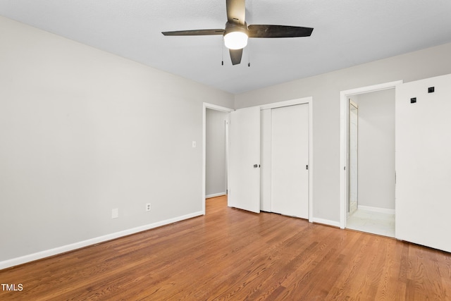 2917 Trail Six, Burlington, NC 27215 - unfurnished bedroom with wood finished floors, baseboards, a closet, and a ceiling fan