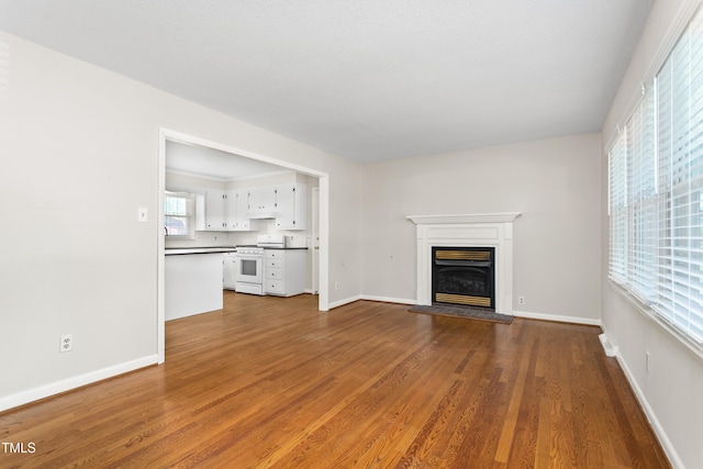 2917 Trail Six, Burlington, NC 27215 - unfurnished living room with dark wood-type flooring, a glass covered fireplace, and baseboards