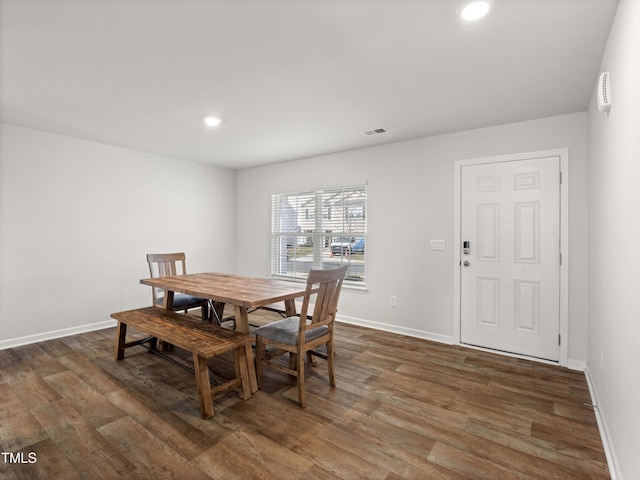 6858 Keeneland Dr, Whitsett, NC 27377 - dining area featuring visible vents, dark wood-style flooring, and baseboards