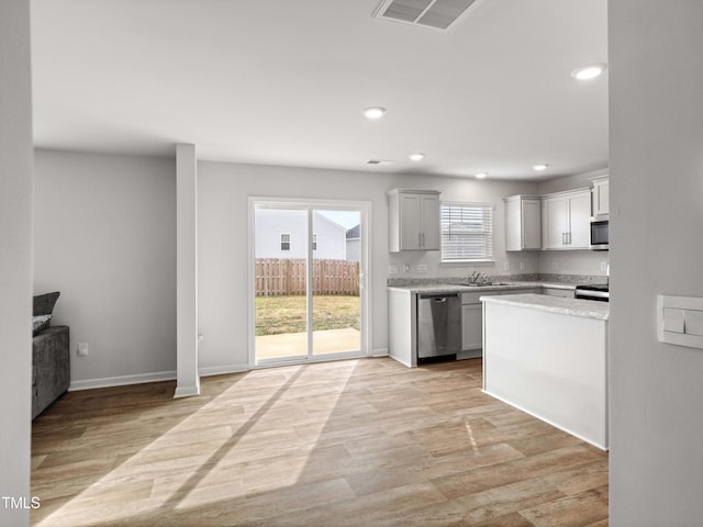6858 Keeneland Dr, Whitsett, NC 27377 - kitchen featuring appliances with stainless steel finishes, light wood-type flooring, recessed lighting, and visible vents