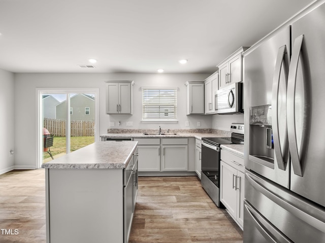 6858 Keeneland Dr, Whitsett, NC 27377 - kitchen featuring recessed lighting, appliances with stainless steel finishes, a wealth of natural light, and a sink