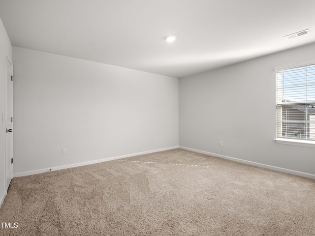6858 Keeneland Dr, Whitsett, NC 27377 - spare room featuring visible vents, carpet flooring, and baseboards