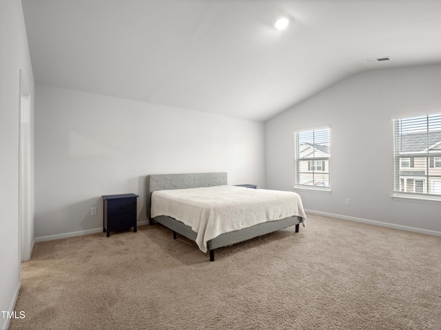 6858 Keeneland Dr, Whitsett, NC 27377 - carpeted bedroom featuring baseboards, vaulted ceiling, and visible vents