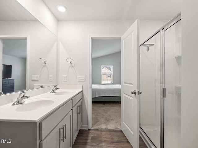 6858 Keeneland Dr, Whitsett, NC 27377 - ensuite bathroom featuring a sink, ensuite bathroom, a shower stall, and wood finished floors