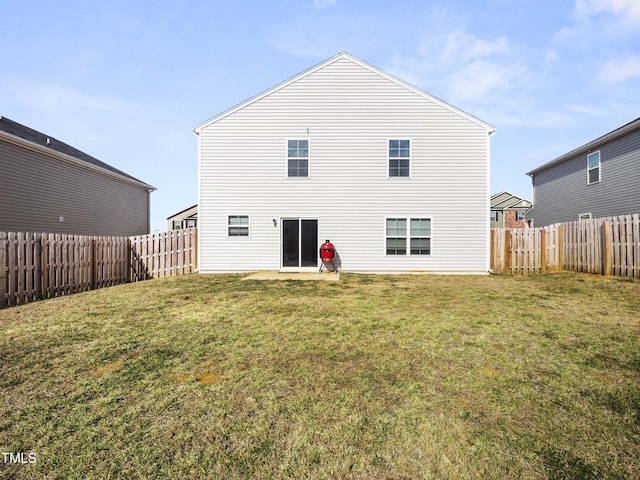 6858 Keeneland Dr, Whitsett, NC 27377 - rear view of house featuring a lawn and a fenced backyard