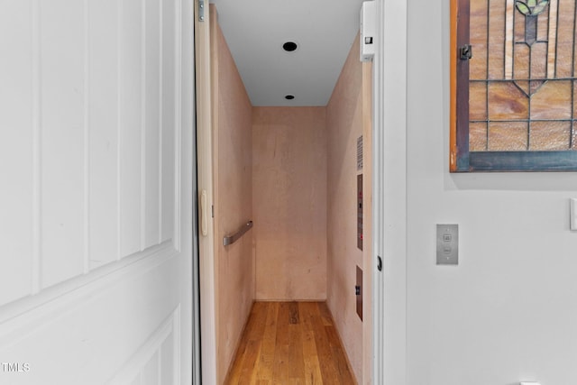 hall featuring elevator and light wood finished floors