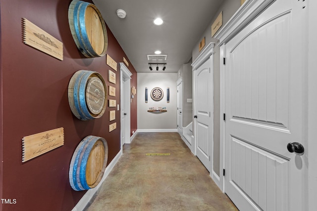 corridor with recessed lighting, baseboards, visible vents, and concrete floors