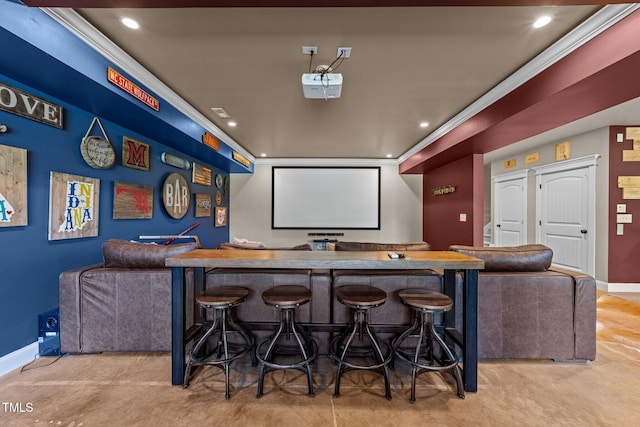 home theater with baseboards, ornamental molding, indoor bar, and recessed lighting