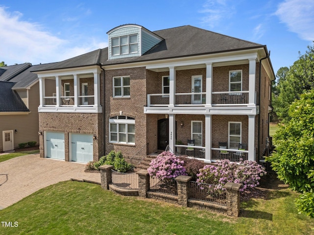 view of front facade with covered porch, brick siding, and a balcony
