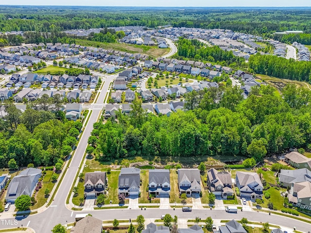 drone / aerial view with a view of trees and a residential view