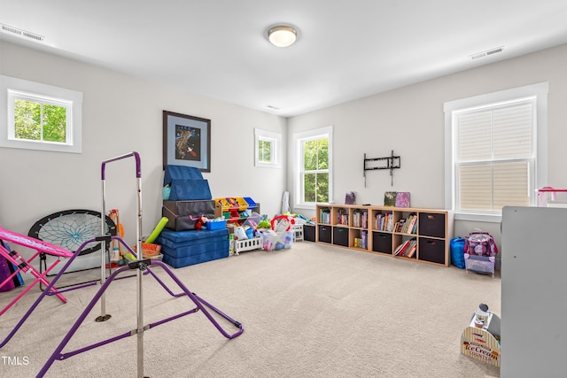 game room with carpet floors, visible vents, and a healthy amount of sunlight