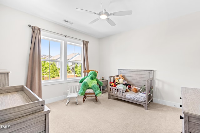carpeted bedroom featuring baseboards, ceiling fan, and visible vents